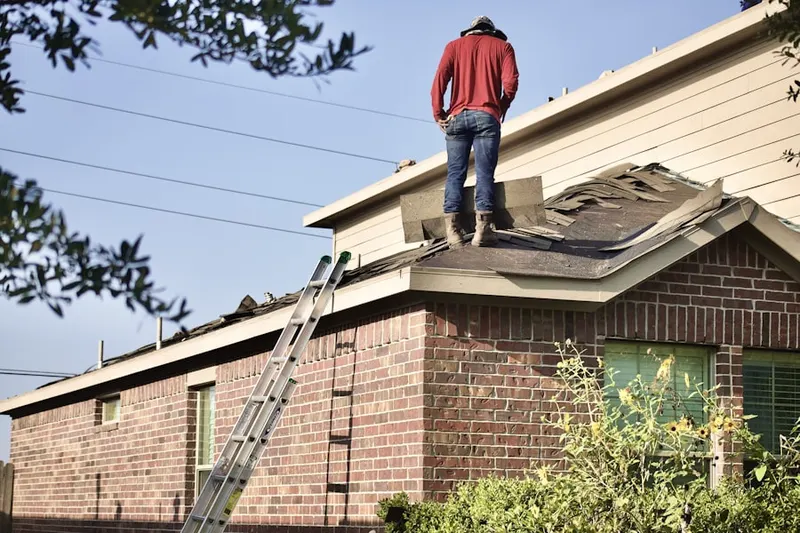 Professional roofer working on a residential roof in Bedford Hills